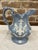 A 19th century blue jasperware pitcher with white sprigged floral and neoclassical rococo scroll on the pitcher body,...
