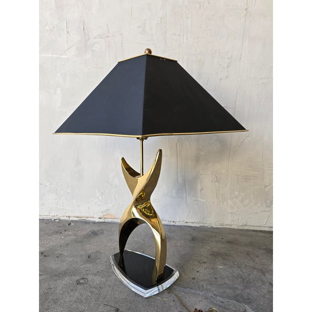 Absolutely stunning figural brass lamp with black acrylic and lucite base. Shade is solid brass and as heavy as the lamp....