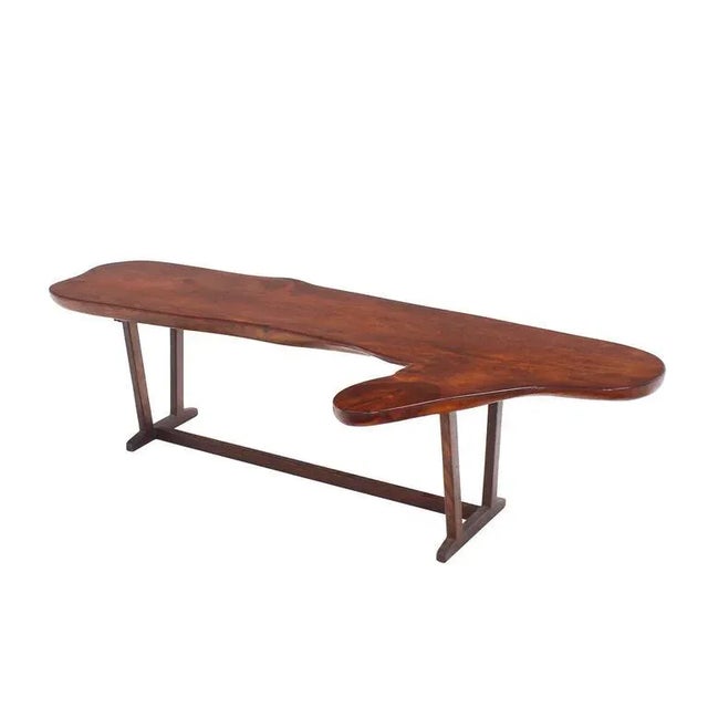 Very nicely built organic shape coffee table or bench. Nice thick solid wood top.