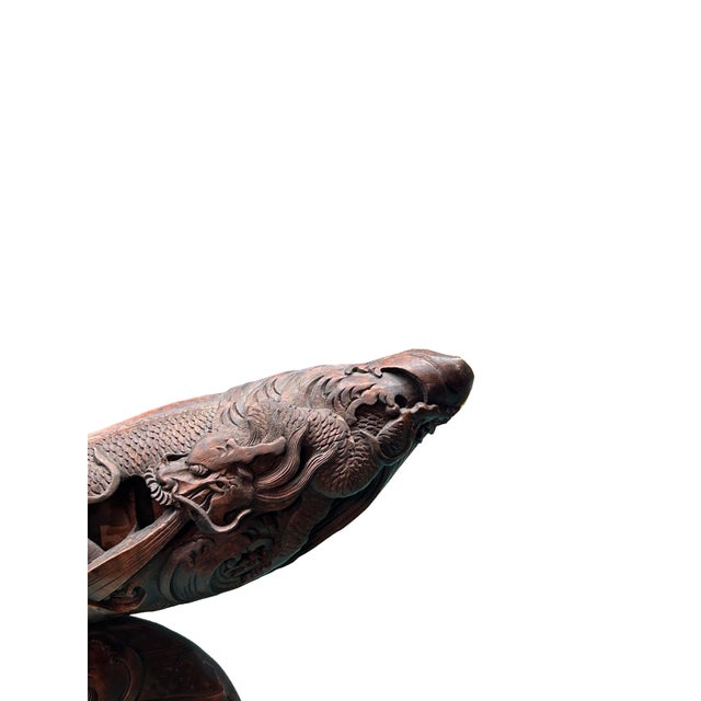 This exquisite hand-carved decorative piece is masterfully fashioned from a natural, curved segment of bamboo root,...