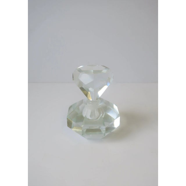 A very beautiful and substantial crystal perfume vanity bottle with a faceted octagonal base and 'diamond' solitaire top...