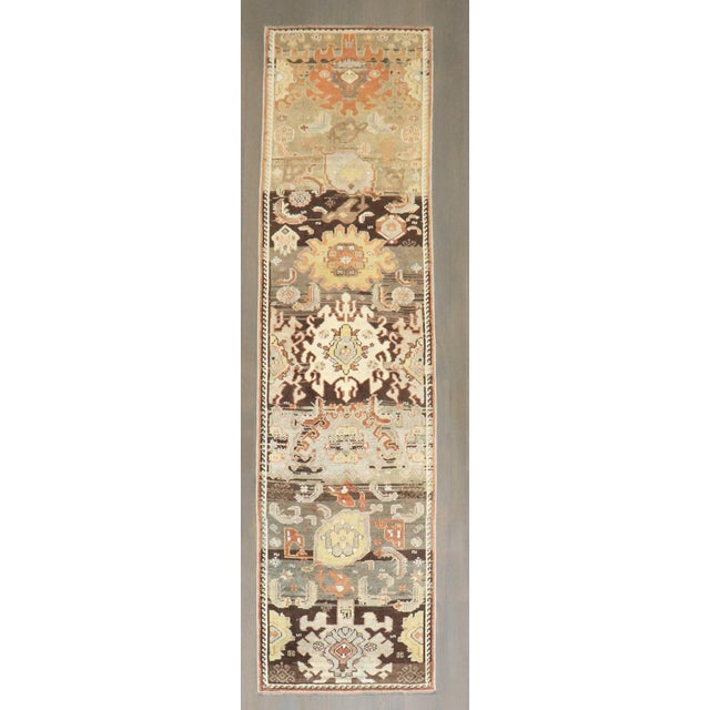 An early 20th-century narrow Northwest Persian runner with large palmettes on a multi-abrashed field throughout. Details...