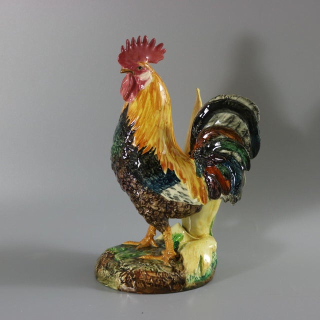 Delphin Massier Majolica figural vase which features a cockerel/rooster stood in front of a vase, which is modelled in the...
