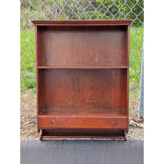 This mid-century modern cherry wood wall shelf brings functional vintage character to any contemporary interior. Crafted...