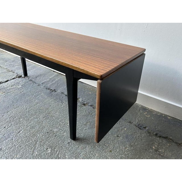 A unique Mid-Century coffee table with an extendable top, made by English manufacturer Nathan. The tabletop slides along...