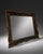 Ornate decorative wall mirror featuring a black frame with antique gold detailing and carved-style scrollwork. The piece...