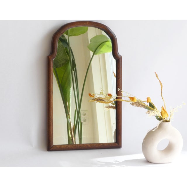 An antique arched wooden mirror with a nice scalloped frame made in the 19th century in the Netherlands. The mirror dates...
