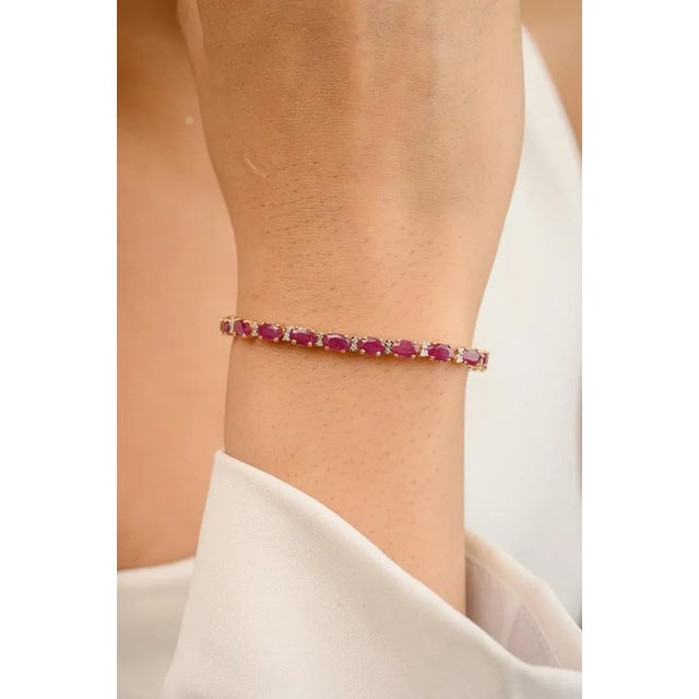 This is part of Chairish’s Fine Jewelry assortment. This Diamond Ruby Tennis Bracelet in 14K gold showcases 28 endlessly...