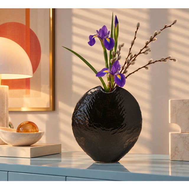 A vintage, Japanese ceramic ikebana vase, with a flat, rounded form and textured surface. Original labels are attached.