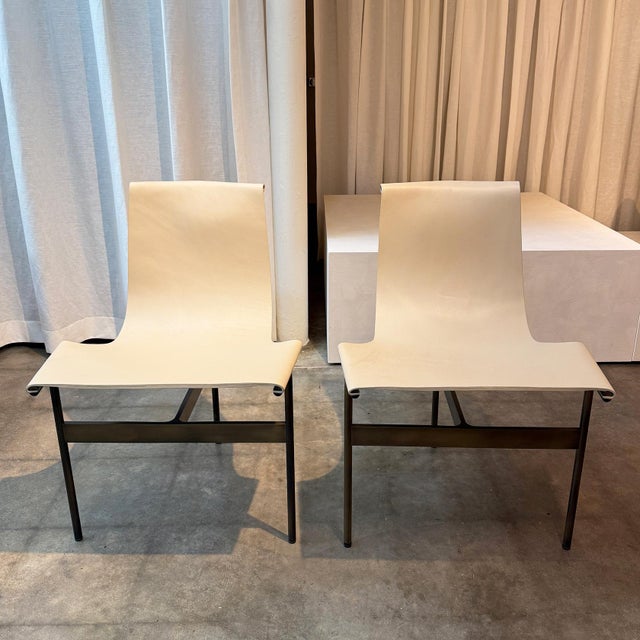 Set of two TG-10 dining chairs designed by William Katavolos, Ross Littell, and Douglas Kelly with cream saddle leather...