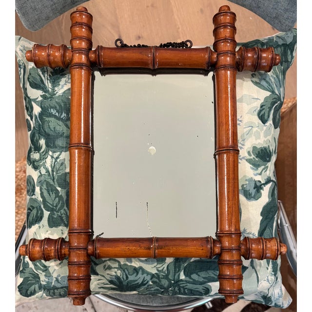 A charming antique French wall mirror featuring turned faux bamboo frame in richly honey patinated fruitwood. The...