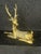 This is a vintage brass sculpture depicting a reclining deer associated with the Hollywood Regency style. Solid brass with...