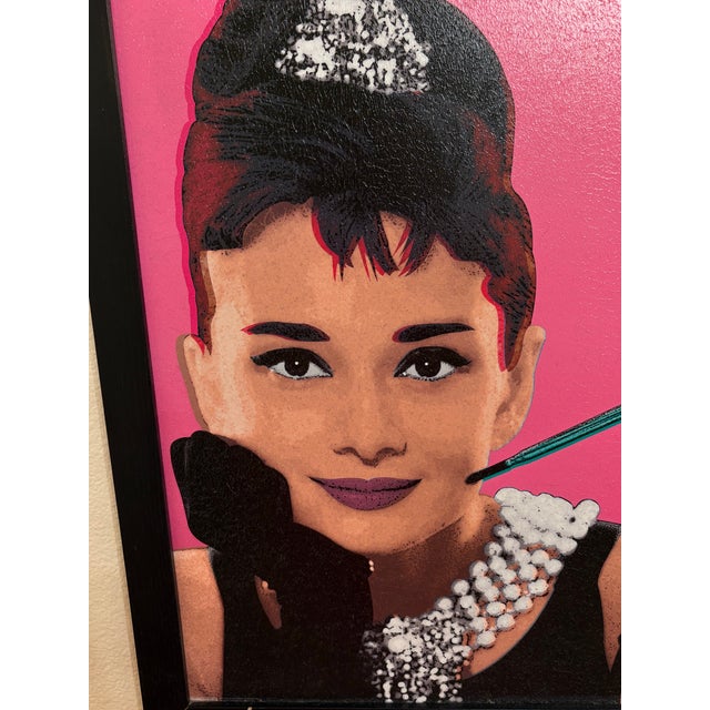 a textured lithograph picture of Audrey Hepburn in the early 1960's. This is a recreation of a famous silk screen created...