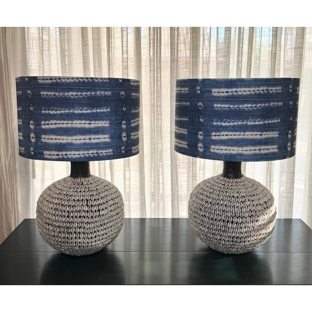 Pair of South Pacific cowrie shell table lamps from Nautical Luxuries of Newport Beach. The dark brown faux leather bodies...