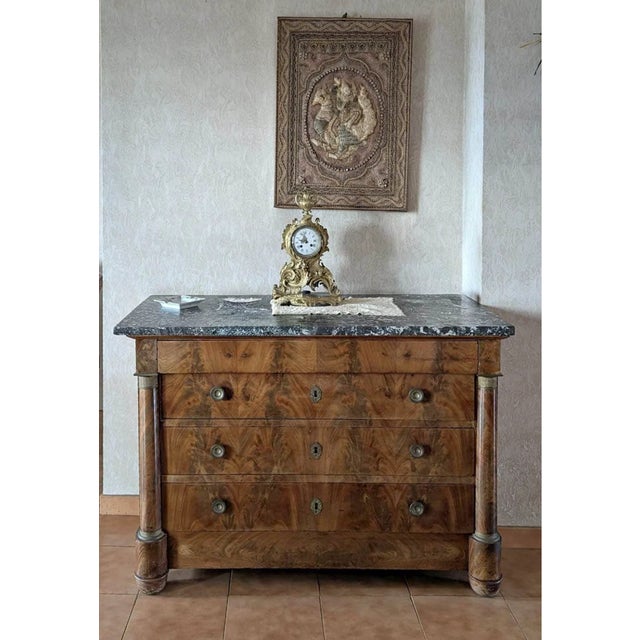 A handsome French Louis Philippe four-drawer commode in beautifully grained burled walnut with original black and white...