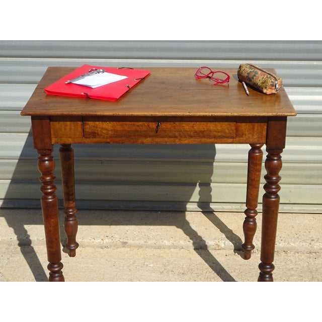 Charming Louis Philippe style desk, mid-19th century, crafted entirely from solid walnut. The top has rounded edges and is...