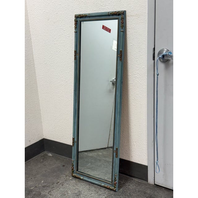 Design Plus Gallery presents a Vintage Mirror. This tall rectangular mirror has a painted blue-green frame with gilt...