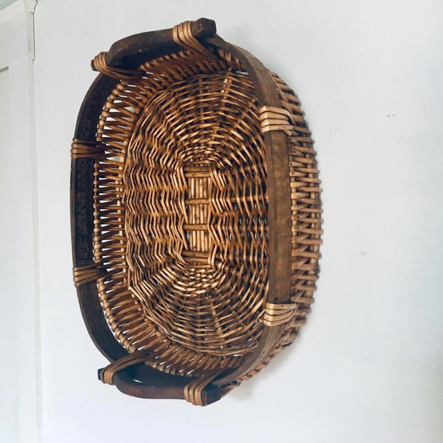 Vintage French woven reed basket tray with carved handles, woven over wood framework with wood reinforcement at the top....