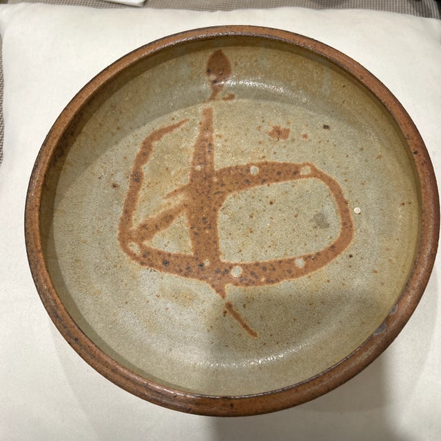 Stunning shallow round bowl or serving tray with a terra cotta stoneware base and a gorgeous glaze! Expertly balances a...