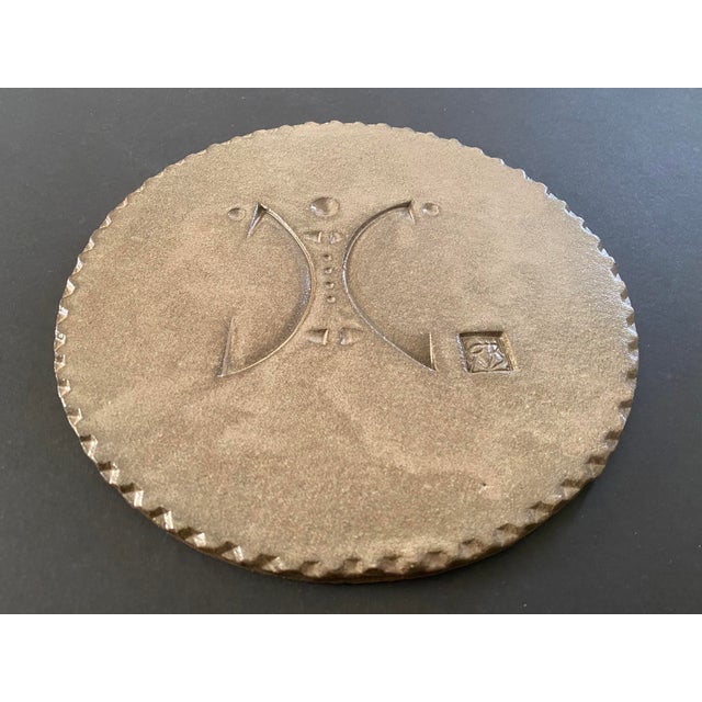 A rare midcentury Paolo Soleri Arcosanti Cosanti pottery tile featuring an abstract figural design.