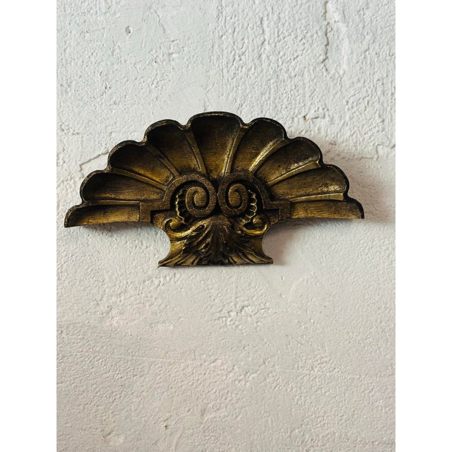 This decorative antique architectural piece is a striking fan-shaped design inspired by a scallop shell, accented with...