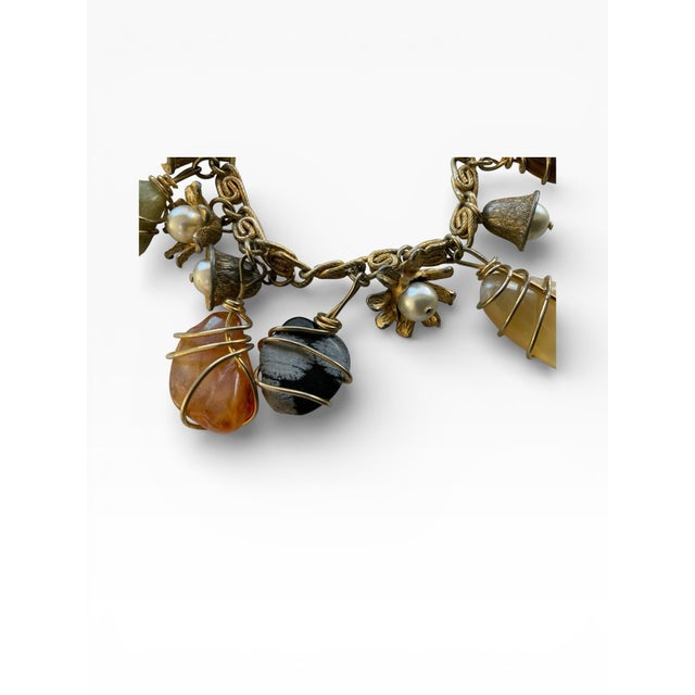 This is a vintage gold-tone wire-wrapped natural gemstone link bracelet with small pearls