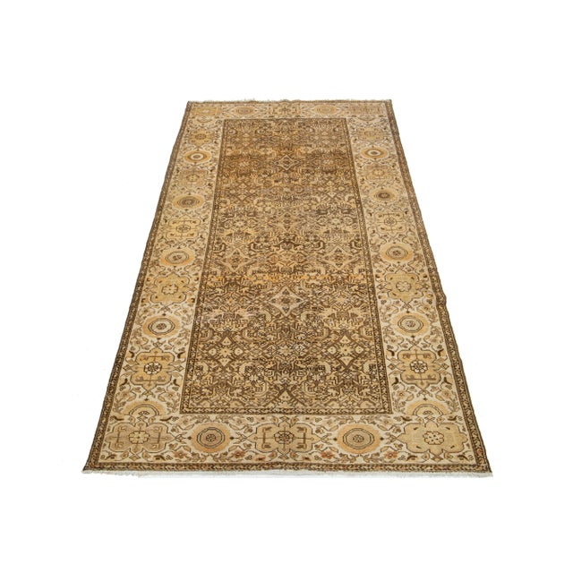 This antique Persian Malayer rug is hand-knotted wool. The design features a beautiful combination of beige and orange as...