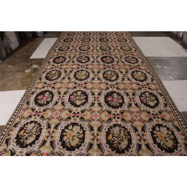 Handwoven in the United States circa 1950-1960, this large size vintage wilton carpet is an ode to the idyllic European...