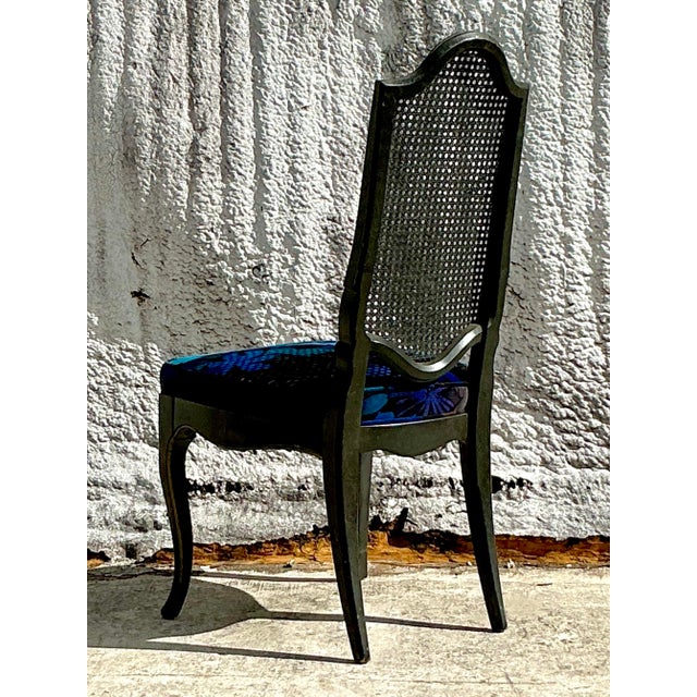 Enhance your space with the timeless sophistication of this vintage Regency Jack Lenor Larsen upholstered cane chair....