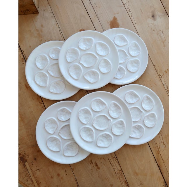Set of 6 antique white earthenware oyster plates. Their iconic shape, with six compartments for oysters and a central...
