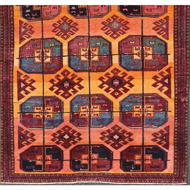 Measures: 5'0 x 8'10 Vintage Wool Ersari Rug in Wool with Gul Design in Orange, Blue, and Brown. Keivan Woven Arts; rug...