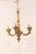A French three-light gilt and carved wood column chandelier from the mid 20th century. This vintage hanging light from...