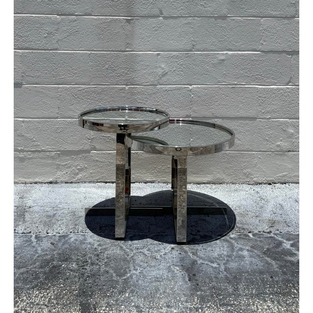 Minimal and quietly architectural, this set of vintage side tables pairs polished chrome frames with mirrored glass tops...