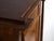This antique biedermeier secrétaire in walnut wood features an architectural pediment over a symmetrical body with two...