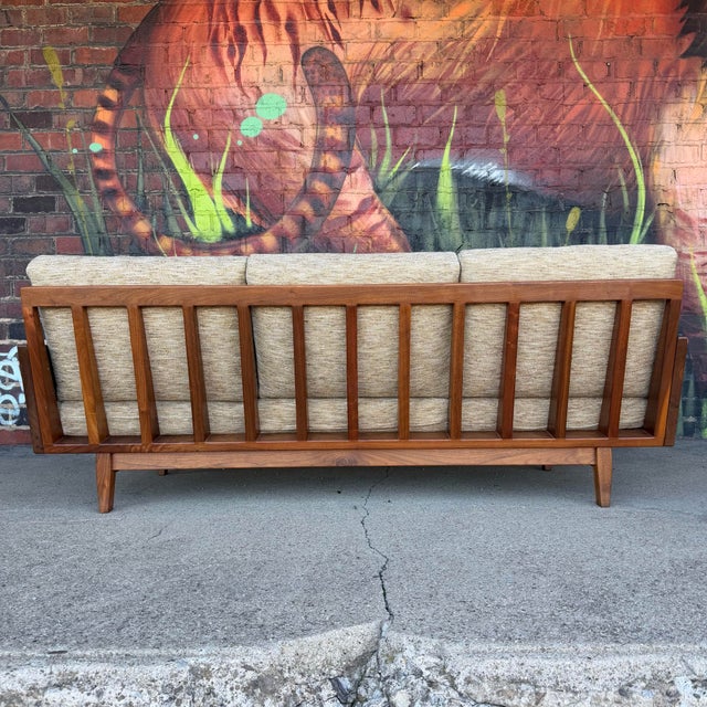Amazing Arden Riddle solid walnut American studio Sofa. This Sofa in particular has a more interesting designed back with...