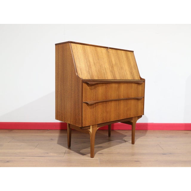 A beautiful secretaire with stunning sculpted handles, this Mid Century Modern Vintage Teak Bureau Secretaire Desk by S...