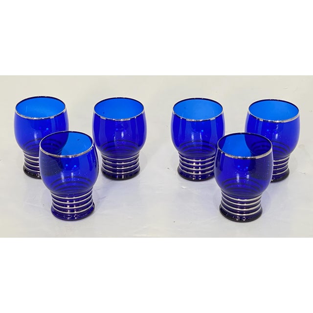 A fine vintage Art Deco cobalt blue martini and cocktail shaker set from France, circa 1930s, featuring pieces of a...