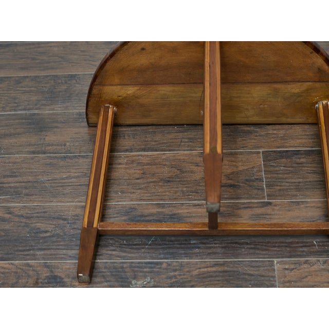This early 20th-century demi-lune table is a striking example of Tramp Art craftsmanship, distinguished by its intricate...