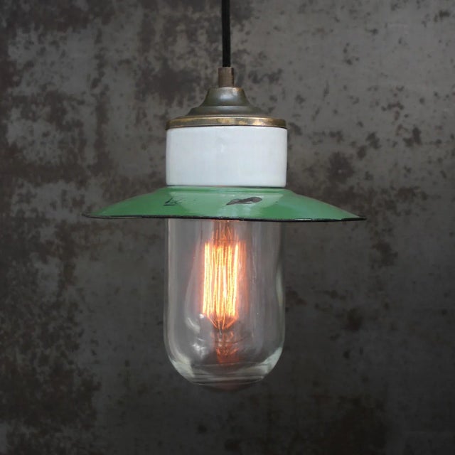 Porcelain Industrial hanging lamp. White porcelain, brass and clear glass. green enamel shade 2 conductors, no ground....