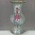 This distinctive ceramic vase features elegant peacock-form handles finished in rich plum flambe glaze against mottled...