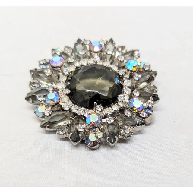 1960s rhodium plated prong set unfoiled open backed round faux-black diamond center with prong set marquise faux-black...