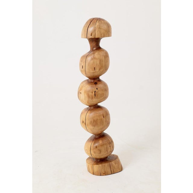 Carved from a single solid log, this sculpture has the presence of an artifact from another time. The rhythmic, stacked...