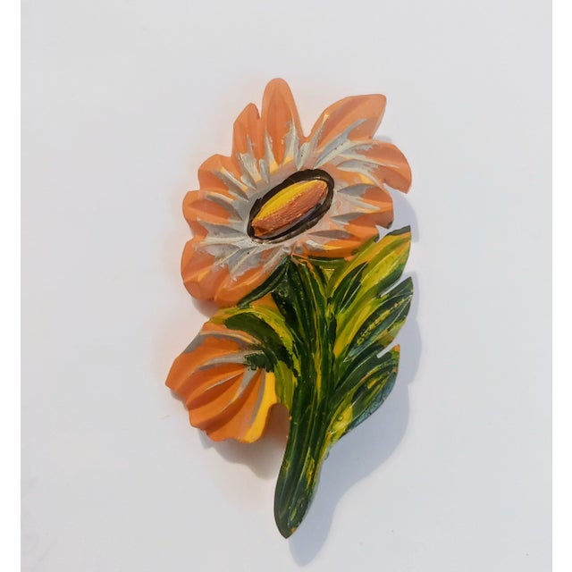 Here's a whimsical floral brooch circa 1920s-30s. The piece was carved from a slab of celluloid, not bakelite though it...