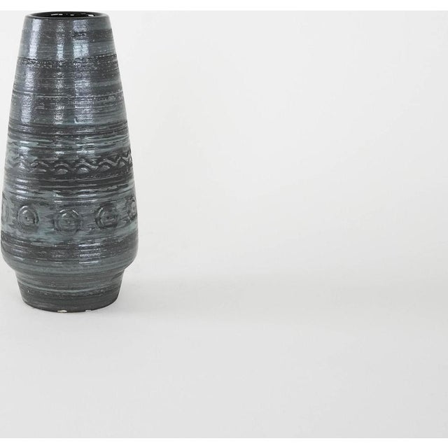 The ceramic vase was made in the 1960s in Denmark. It is decorated in shades of gray with horizontal, rhythmic grooves and...
