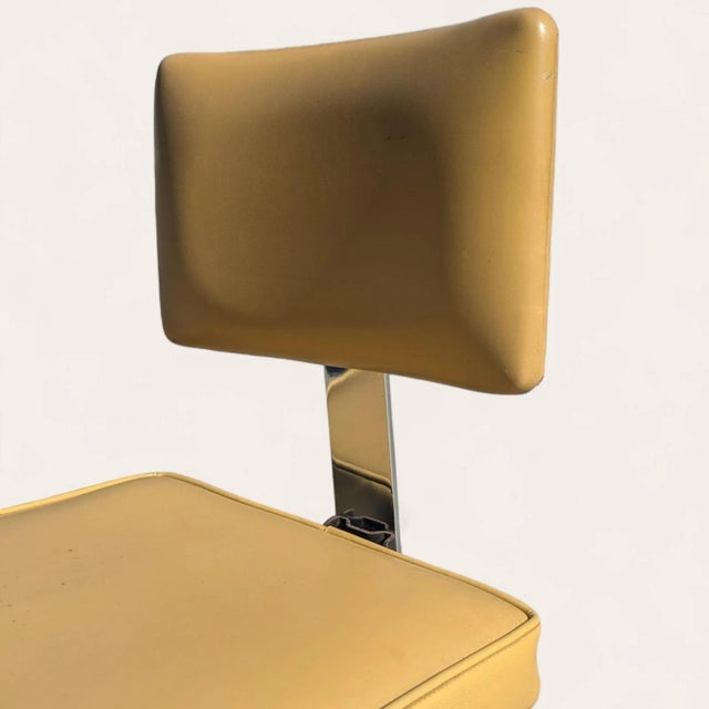 A vintage office chair by InterRoyal Corp. featuring a sturdy steel frame, chrome accents, faux-leather upholstery, and...