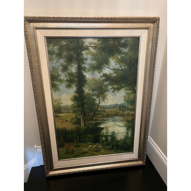 Offered is a vintage framed landscape oil print on canvas. This piece features a timeless scene with neutral colors and a...