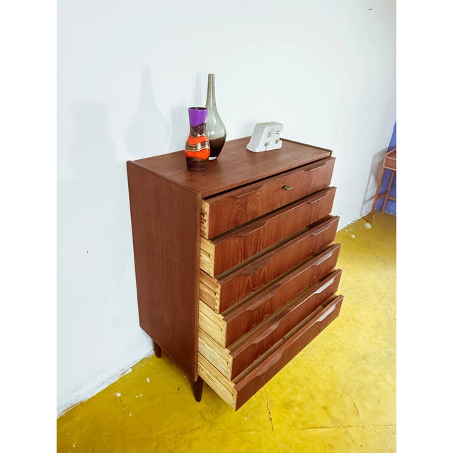 Vintage Danish teak chest of drawers from the 1950s, featuring six stacked drawers with a regular pattern, integrated...
