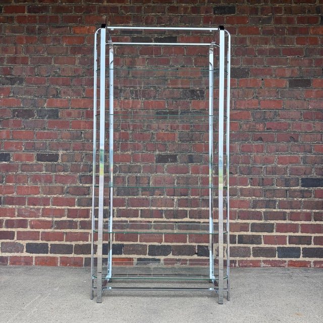 Sleek vintage Mid-Century Modern chrome and glass étagère or display shelf, circa 1970s. The tall architectural frame is...