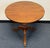 charming round end table with a warm wood finish and a distinctive carved pedestal. The textured pineapple detail adds...