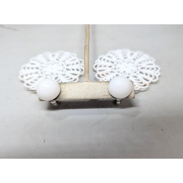 1960s rhodium plated white Lucite ball top with round filigree cut out drop clip and screw back earrings. Marked...